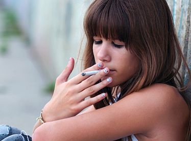 Teenage girl smoking cigarette