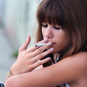 Teenage girl smoking cigarette